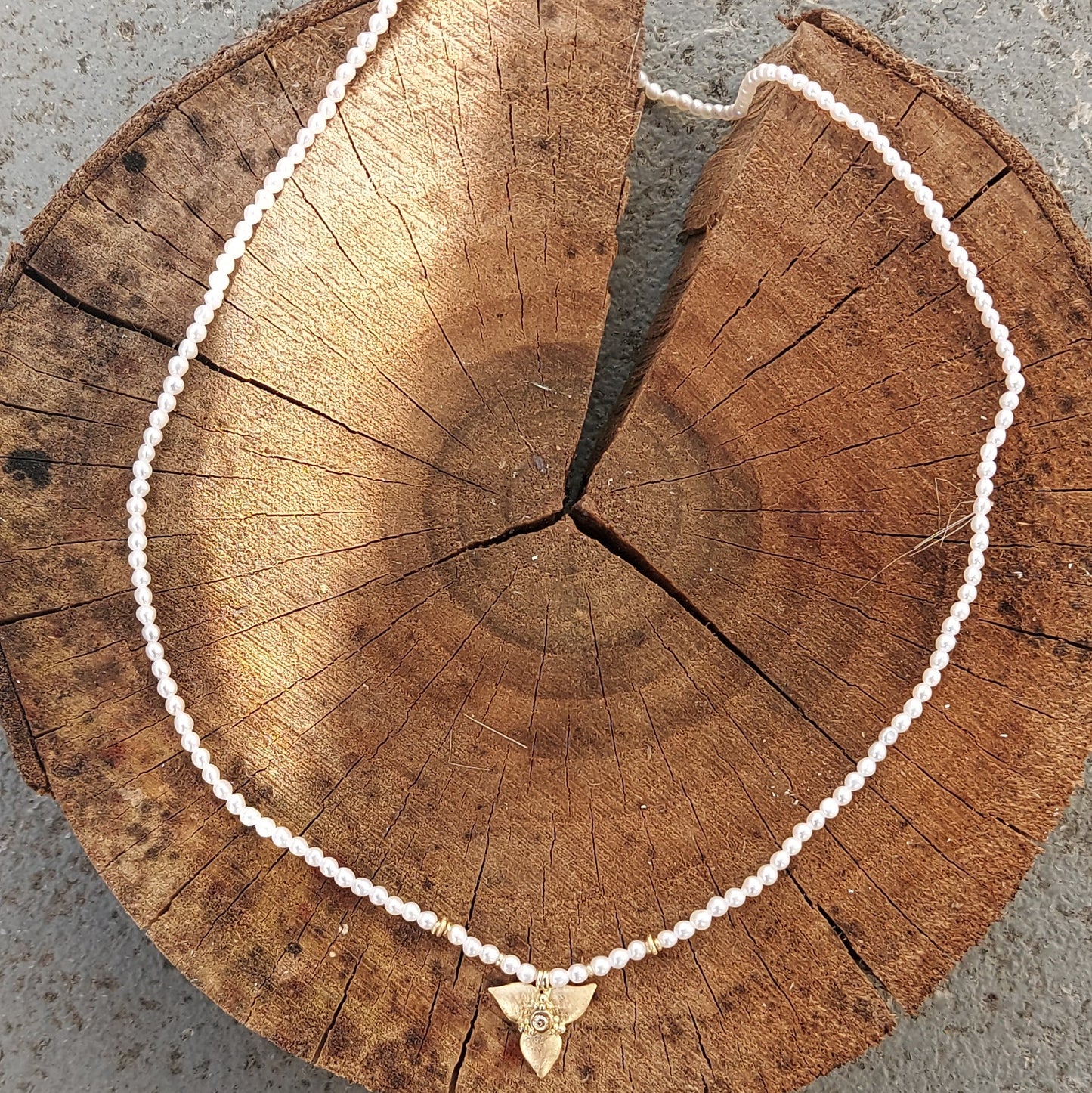 Pearl chain with golden bloom