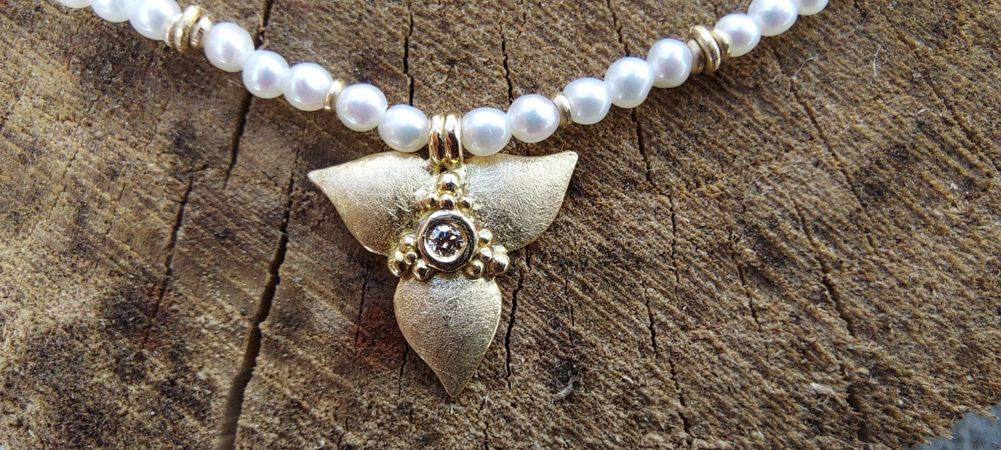 Pearl chain with golden bloom